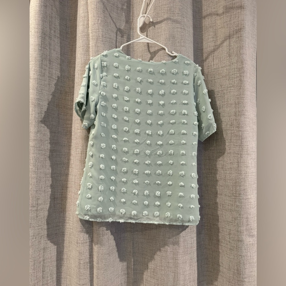 No longer fits, but really cute!! Mint green textured shirt. Size medium
